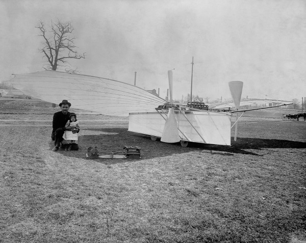 ca. 1901 --- Aviation pioneer Gustave Whitehead is pictured with his daughter Rose and plane number 21. Some aviation historians believe Gustave Whitehead preceeded the Wright brothers by as much as three years with a manned flight. --- Image by © CORBIS